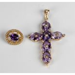 An attractive miniature Brooch, with central amethyst stone surrounded by multiple pearls,