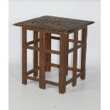 A Middle Eastern carved folding Table, with square carved top depicting flowers etc.