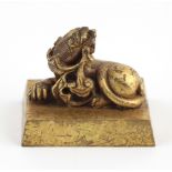 A gilt bronze Chinese Ruyi Seal, of rectangular form with mythical beast, 2 1/4" (5.5cms).