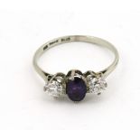 A very fine platinum Ring, with centre amethyst stone flanked by two diamonds.