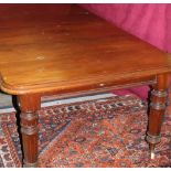 A large Victorian mahogany Dining Table, with two spare leaves, on turned and reeded legs,