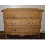 A Provincial French style bleached oak Chest, of three long drawers with brass drop handles.