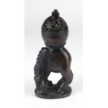 An unusual Chinese bronze Censor, the bulbous top with a pierced dome cover with reclining infant,