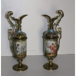 An attractive pair of 19th Century hand painted Continental porcelain and brass mounted Ewers,