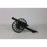 A heavy cast iron Cannon Barrel on a Carriage base.