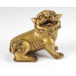 A very attractive Chinese gilt bronze Fo Lion, seated and facing right with mouth open,