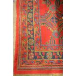 A quality heavy woolen crimson ground Turkish Carpet, the centre with geometric design,