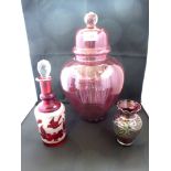 3 PIECES OF CRANBERRY STYLE GLASS INCLUDING 2 VASES AND A BOTTLE