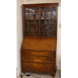 Georgian oak bureau bookcase, with glazed doors over the fall front and four drawers upon turned