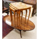 Nest of three golden oak side tables, with tooled leather glazed tops, largest 22" high, together