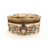 Naples porcelain serpentine casket, the hinged cover and sides with relief moulded scenes of