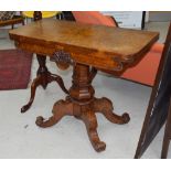 Victorian figured walnut foldover card table with green baize surface on central octagonal