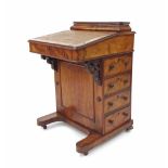 Victorian figured walnut Davenport, with a hinged compartment and fall-front over four drawers and