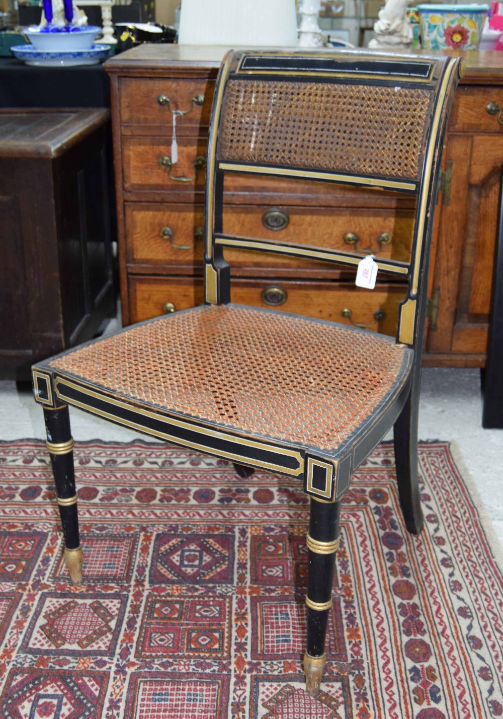 Regency ebonised and gilded bergere chair, 33" high, 21" wide