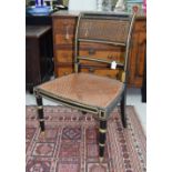 Regency ebonised and gilded bergere chair, 33" high, 21" wide