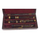 Old rosewood eight key flute in D, stamped C. Cotcher, Birmingham, within a fitted case with