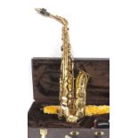 Alto saxophone inscribed 'The Marcato', gold lacquered, ser. no. 6129309, with crook and mouthpiece,