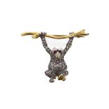 Novelty brooch modelled as a monkey hanging from a branch, set with garnet eyes and diamond