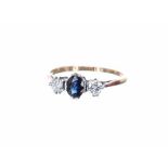 18ct sapphire and diamond three stone ring, the oval sapphire with round brilliant-cut diamonds to