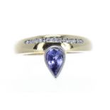 Bespoke 18k tanzanite and diamond ring, with a channel of thirteen round brilliant-cut diamonds over