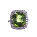 Fine quality peridot and diamond white gold cushion cluster ring, the peridot 12.60ct, in a surround