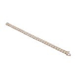 9ct diamond line bracelet, set with thirty-one links of ten small diamonds, 17gm, 8" long