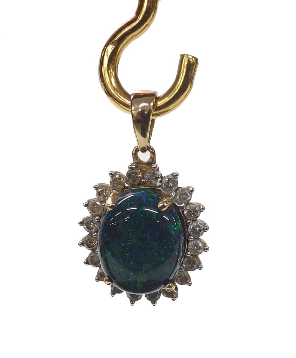 Cabouchon black opal and diamond oval 9ct pendant, the opal measuring 11mm x 10mm, depth 6mm,