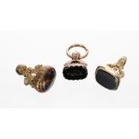 Two gold mounted fobs; also a gilt example (3)