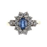 18k sapphire and diamond oval cluster ring, the sapphire 0.50ct approx in a surround of twelve round