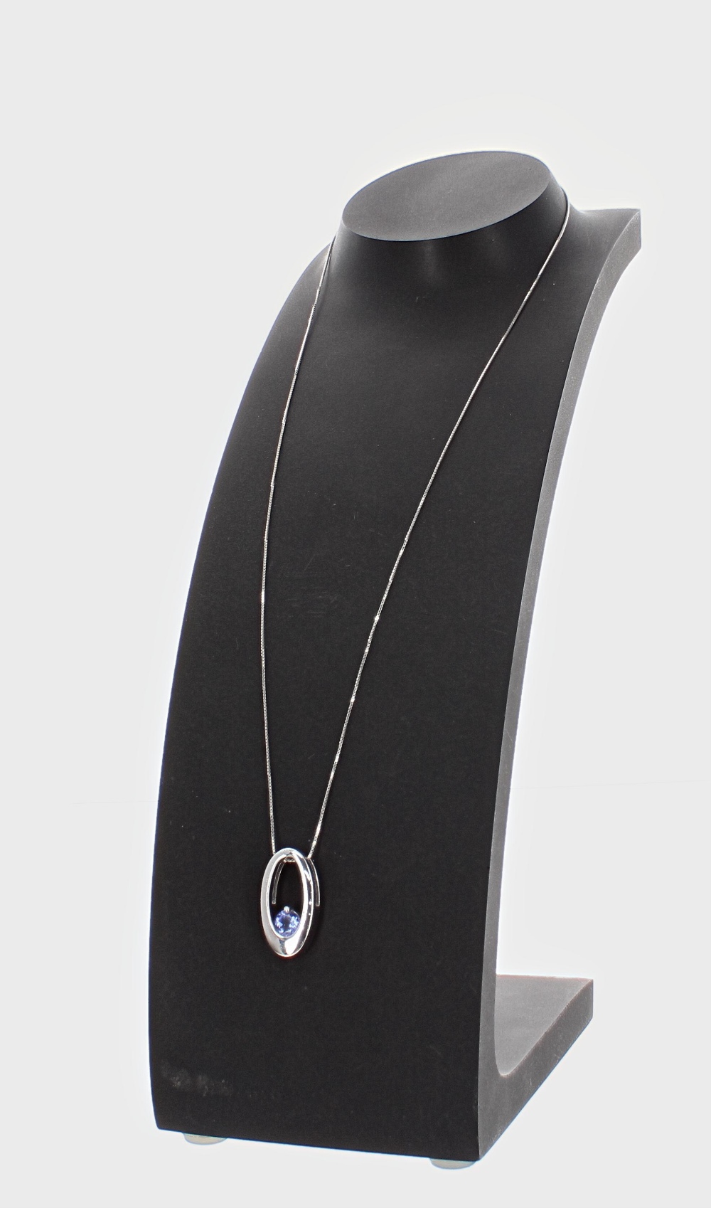 Attractive contemporary 14k oval shaped pendant set with a single tanzanite, with 14ct fine link