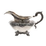 William IV silver cream jug, with half repousse scrolling acanthus decoration and handle, gilded