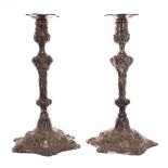 Pair of George III silver candlesticks, repousse decorated with foliate scrolls and assorted