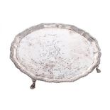 Harrods Limited circular silver salver, with a gadrooned cast border upon four pad feet, London