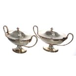 *Matched* Pair of George III oval silver twin-handled lidded tureens, with pedestal bases and beade