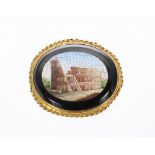 Oval micromosaic brooch depicting a Colosseum, within an onyx and yellow metal surround, 14.5gm,