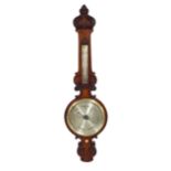 Good walnut 9.5" wheel barometer/thermometer, within a foliate carved shaped case