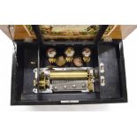 Walnut and rosewood crossbanded music box, the 6.25" cylinder playing eight airs with three