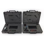 Two Trantec Systems wireless headset microphone units, each within original cases