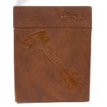 1970s Gibson dealers brochure binder, with brown leather cover embossed with a Gibson Les Paul to