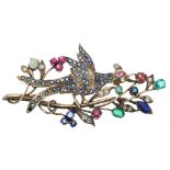 Attractive yellow gold multi gem set brooch, fashioned with an exotic bird amidst a floral