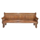 19th century pitch pine pew bench seat, with panelled back and pierced gothic carved arms over the