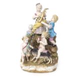 German style porcelain figural group of a lady and gentleman drinking wine and a girl playing a