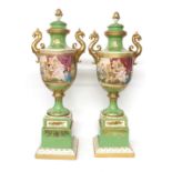 Pair of large Vienna style porcelain urns on stands, with gilt mythological creature handles and