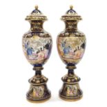 Large and impressive pair of porcelain baluster vases and covers on stands, with figural panels