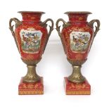 Pair of replica gilt metal and porcelain twin-handled vases, with painted bird panels on a deep