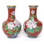 Pair of Japanese cloisonne vases, with pink orchid decoration on a deep orange ground with gilded