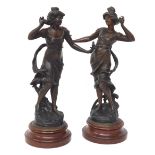 Pair of French spelter figures of dancing ladies holding flowers upon naturalistic bases mounted