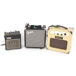 Three small guitar amplifiers including a Fender Rumble 15, a Harley Benton GA5 and a Vox DA5 (Vox