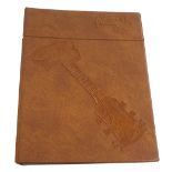 1970s Gibson dealers brochure binder, with brown leather cover embossed with a Gibson Les Paul to