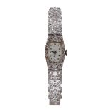 Fine Garrard 1920s platinum and diamond lady's cocktail watch, tonneau silvered dial with Arabic